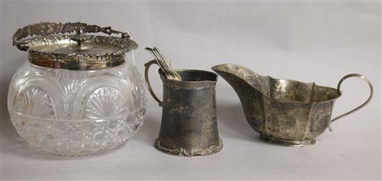 A silver mounted biscuit barrel, a silver mug, silver sauceboat and set of six Victorian silver teaspoons.